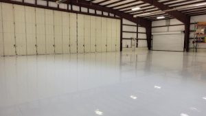New White Shiny COncrete Floor Coating in Univerity School Hangar